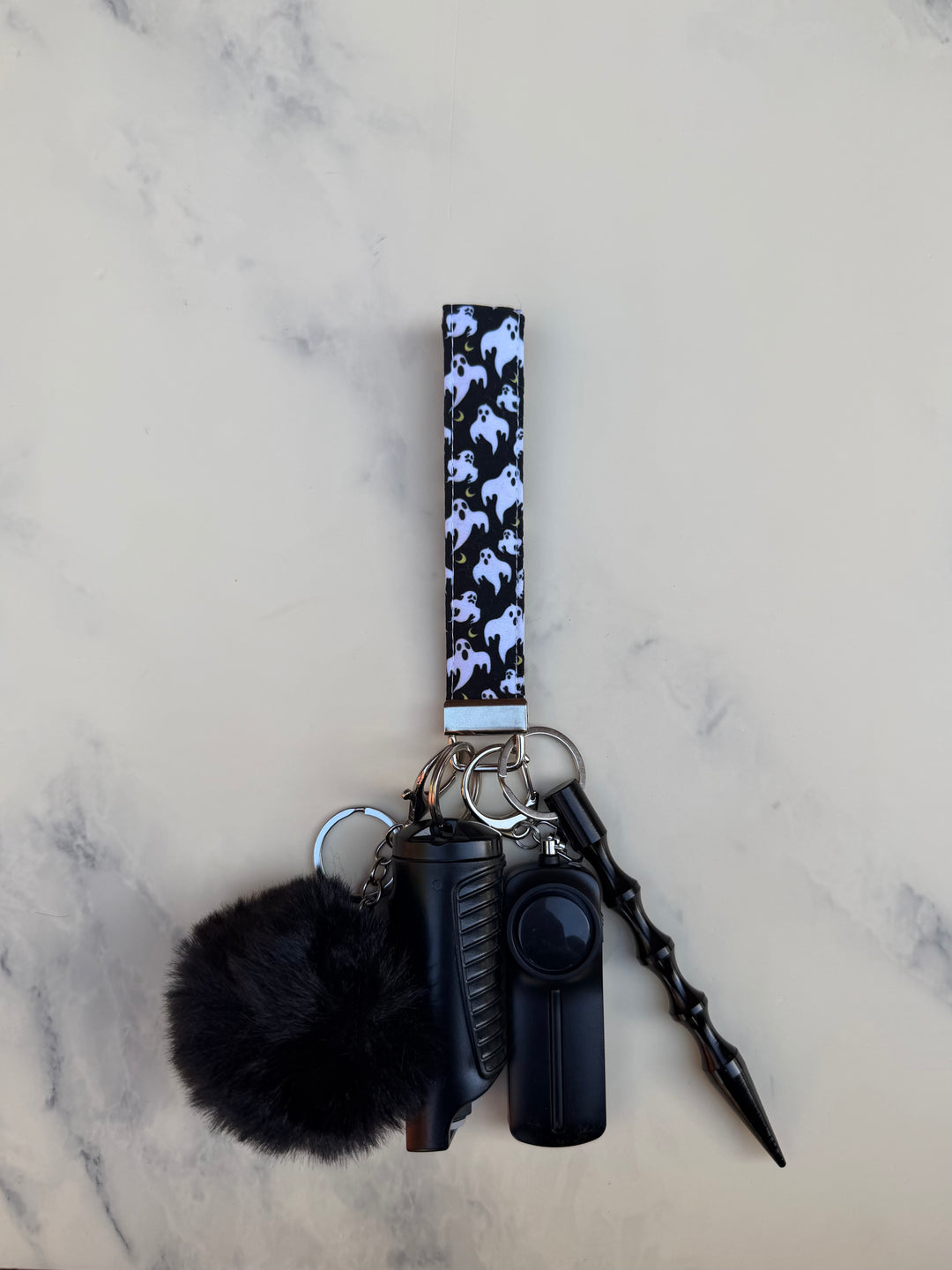 Handmade black and gold ghost self-defense keychain
